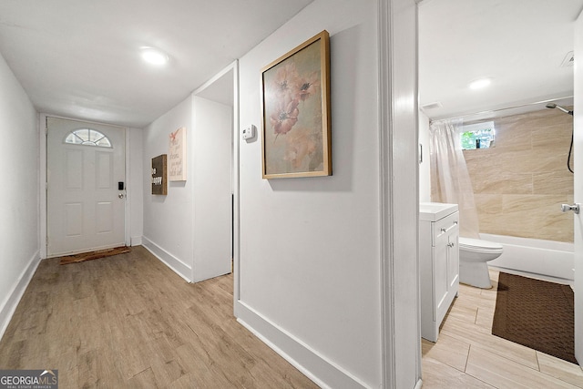 interior space with light wood finished floors and baseboards