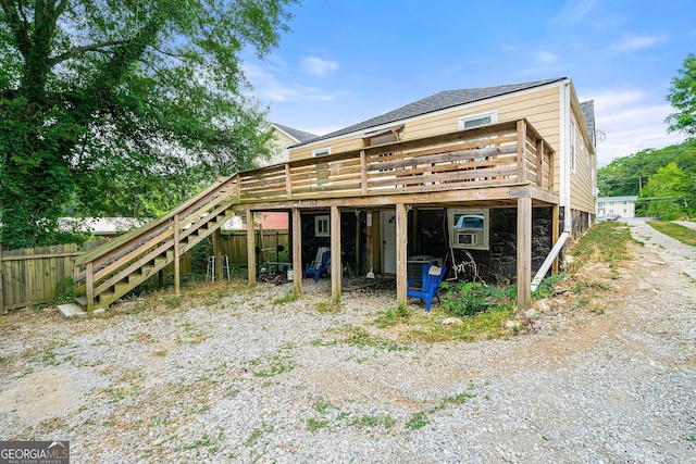 exterior space with a deck, fence, and stairway