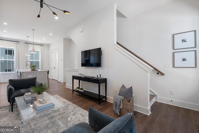 living area with dark wood-style floors, recessed lighting, stairway, and baseboards