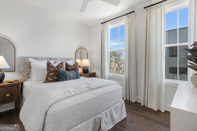 bedroom with a ceiling fan, baseboards, and wood finished floors