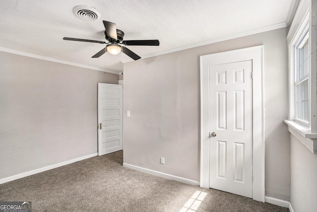 1887 Green Valley Rd, Griffin, GA 30224 - unfurnished bedroom with baseboards, visible vents, ornamental molding, a textured ceiling, and carpet floors