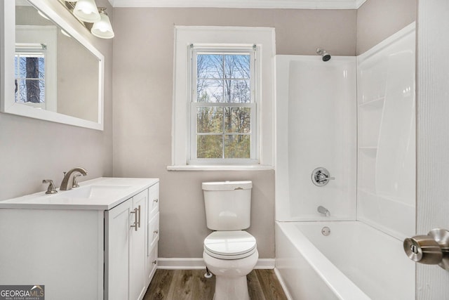 1887 Green Valley Rd, Griffin, GA 30224 - full bath with shower / bathtub combination, toilet, vanity, wood finished floors, and baseboards