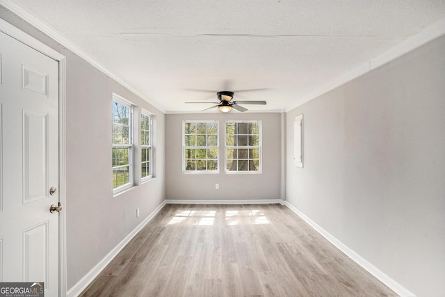 1887 Green Valley Rd, Griffin, GA 30224 - unfurnished room featuring light wood finished floors, ornamental molding, a textured ceiling, and baseboards