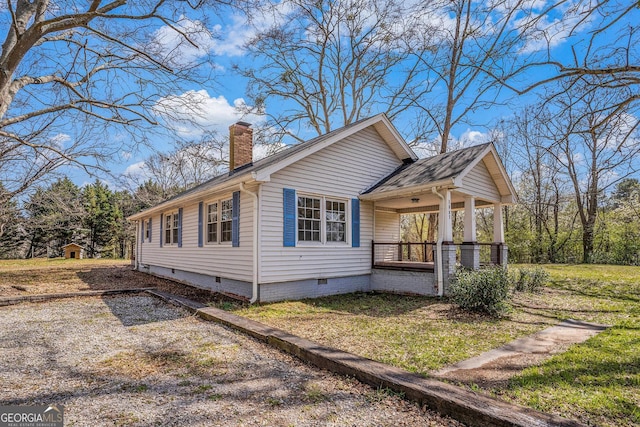 1887 Green Valley Rd, Griffin, GA 30224 - view of side of property featuring crawl space, covered porch, a chimney, and a lawn