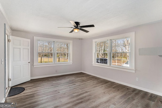 1887 Green Valley Rd, Griffin, GA 30224 - unfurnished bedroom with crown molding, a textured ceiling, baseboards, and wood finished floors