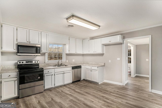 1887 Green Valley Rd, Griffin, GA 30224 - kitchen featuring visible vents, white cabinets, stainless steel appliances, light countertops, and a sink