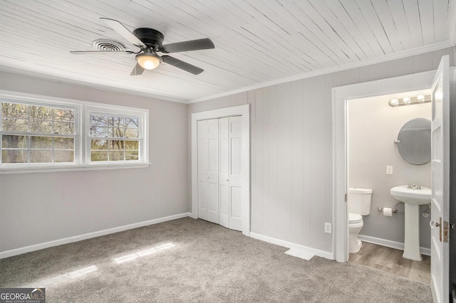 1887 Green Valley Rd, Griffin, GA 30224 - carpeted bedroom featuring a sink, wooden ceiling, ornamental molding, and a closet