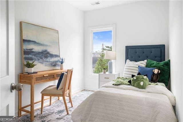 bedroom with visible vents and baseboards