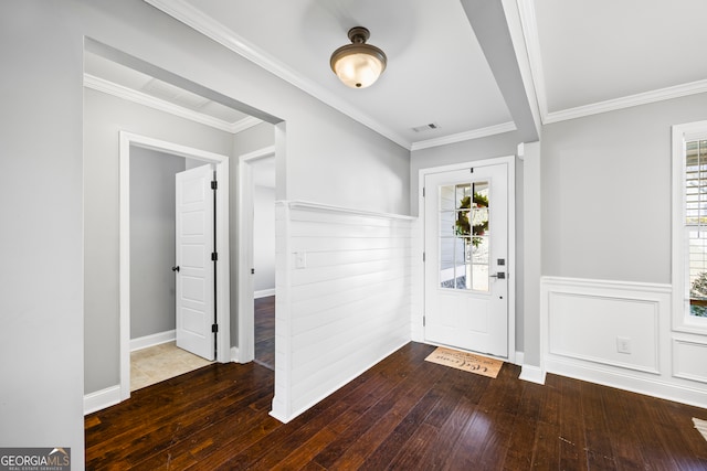 foyer entrance featuring a healthy amount of sunlight, visible vents, and hardwood / wood-style floors