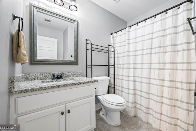 full bath featuring toilet, vanity, visible vents, and tile patterned floors