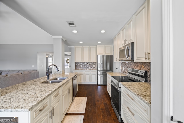 kitchen featuring tasteful backsplash, visible vents, appliances with stainless steel finishes, dark wood-type flooring, and a sink