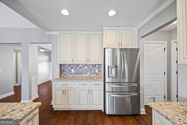 kitchen with tasteful backsplash, dark wood-type flooring, light stone counters, and stainless steel fridge with ice dispenser