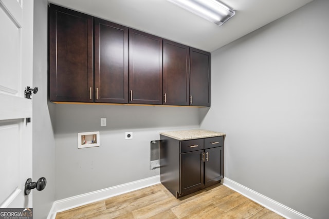 laundry room featuring hookup for a washing machine, baseboards, light wood-type flooring, cabinet space, and electric dryer hookup