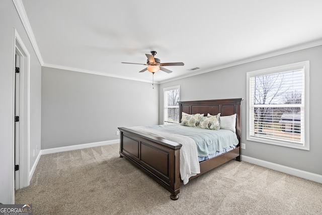 bedroom featuring light colored carpet, crown molding, and multiple windows