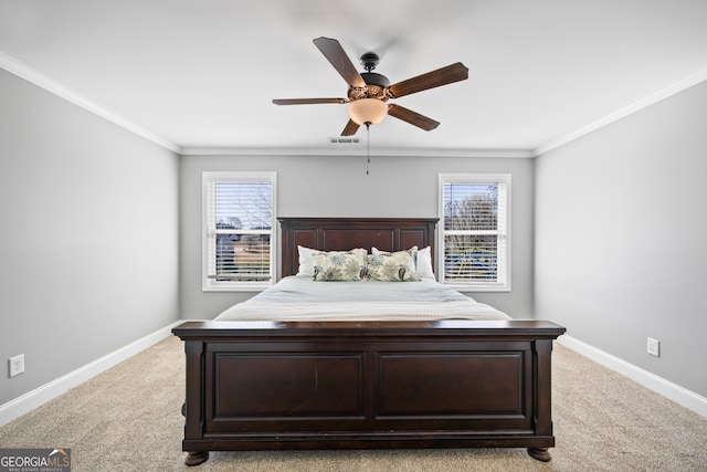 bedroom featuring multiple windows, visible vents, and crown molding