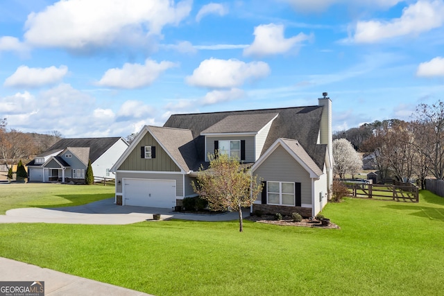 view of front of property with board and batten siding, fence, a garage, driveway, and a front lawn