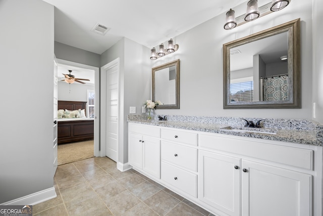 bathroom featuring ensuite bathroom, double vanity, a sink, and visible vents