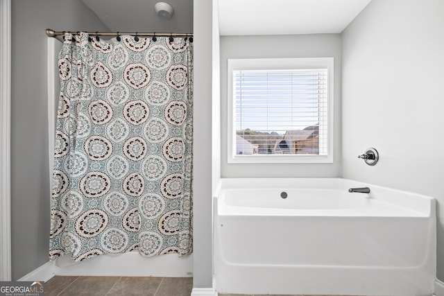 full bathroom with curtained shower, a bathtub, and tile patterned floors