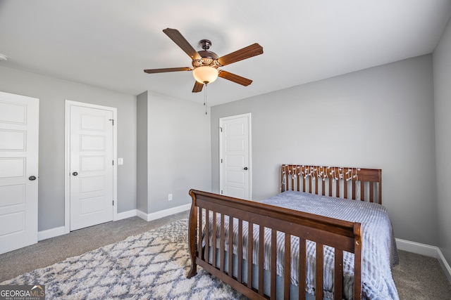 carpeted bedroom featuring a ceiling fan and baseboards