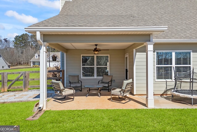 view of patio with a ceiling fan and fence