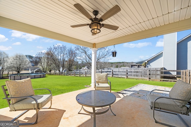 view of patio / terrace with ceiling fan, a fenced backyard, and a fenced in pool