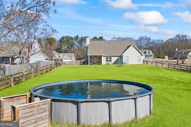 view of swimming pool featuring a fenced backyard, a fenced in pool, and a yard