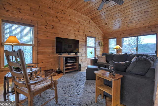 living room with lofted ceiling, ceiling fan, wooden ceiling, wood walls, and wood finished floors