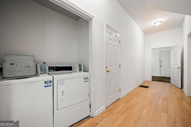 laundry area featuring visible vents, light wood-style floors, laundry area, independent washer and dryer, and baseboards