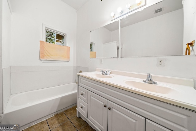 full bathroom with double vanity, tile patterned flooring, a sink, and visible vents