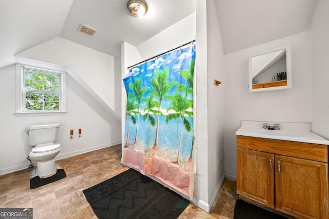 bathroom featuring lofted ceiling, toilet, vanity, visible vents, and baseboards