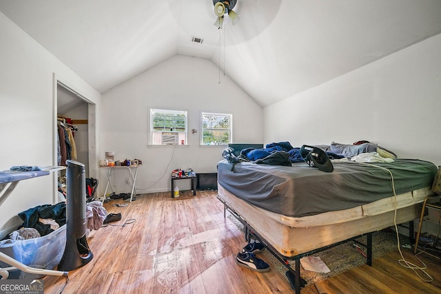 bedroom featuring wood-type flooring, visible vents, vaulted ceiling, ceiling fan, and cooling unit