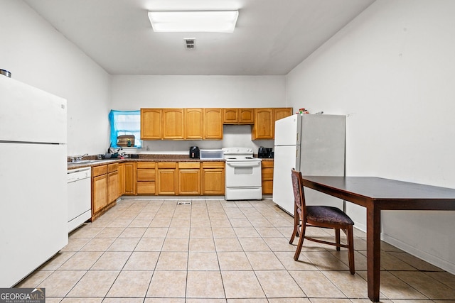 kitchen featuring white appliances, visible vents, a sink, and light tile patterned flooring