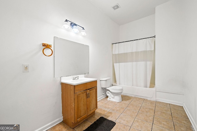 bathroom with toilet, vanity, baseboards, and tile patterned floors