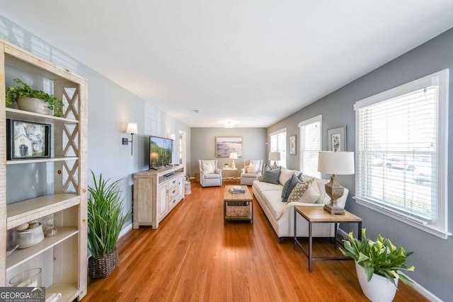 living room featuring light wood finished floors and baseboards