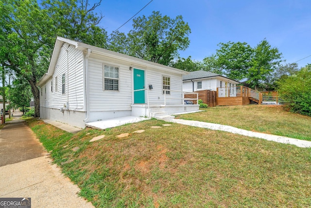 view of front of home with crawl space and a front lawn