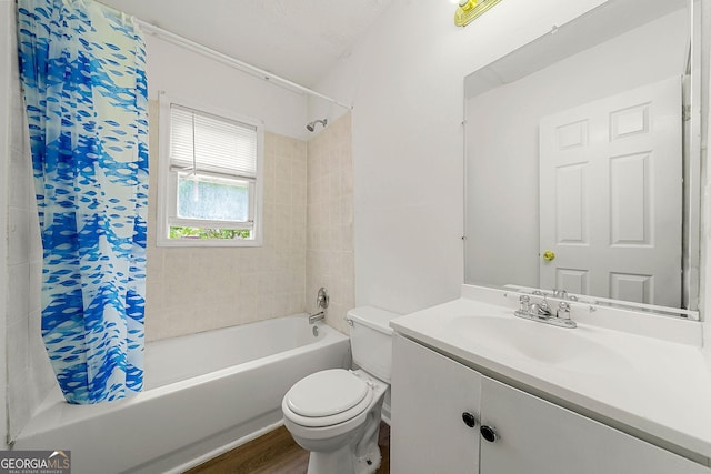 bathroom featuring shower / bath combo with shower curtain, vanity, toilet, and wood finished floors