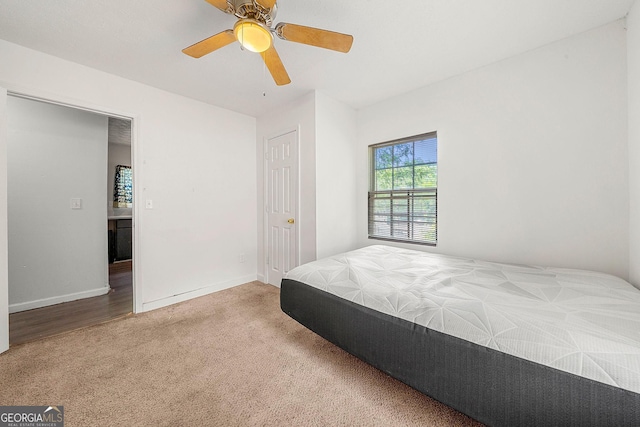 carpeted bedroom with a ceiling fan and baseboards