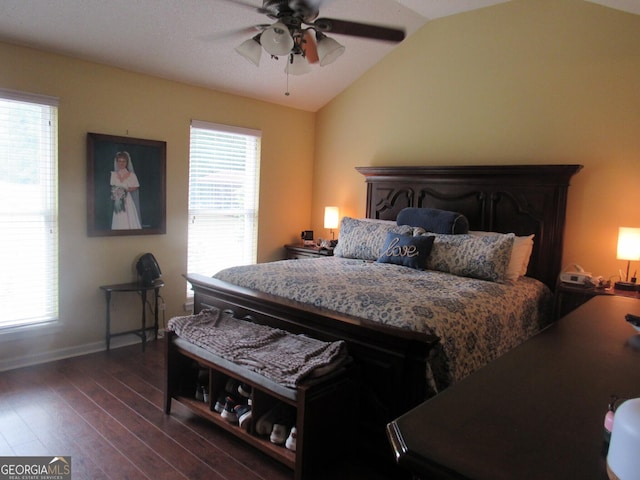 bedroom with dark wood-type flooring, multiple windows, vaulted ceiling, and baseboards