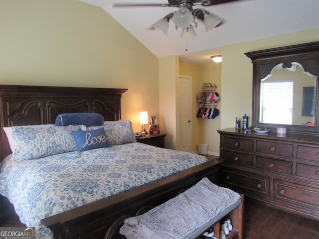 bedroom with a ceiling fan, dark wood-style flooring, and vaulted ceiling