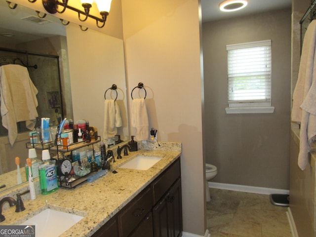 full bathroom with visible vents, a sink, a shower stall, and toilet