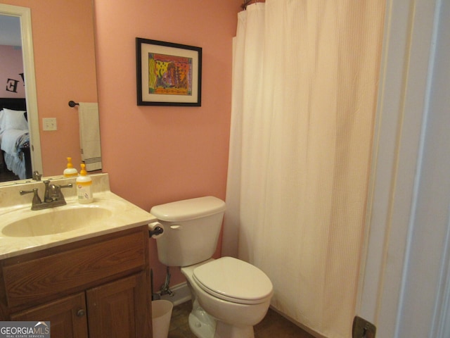 bathroom with ensuite bath, vanity, and toilet