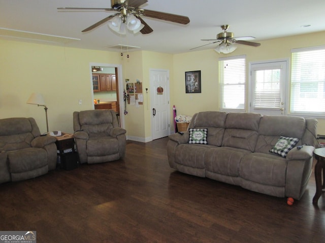 living area with ceiling fan, wood finished floors, attic access, and baseboards