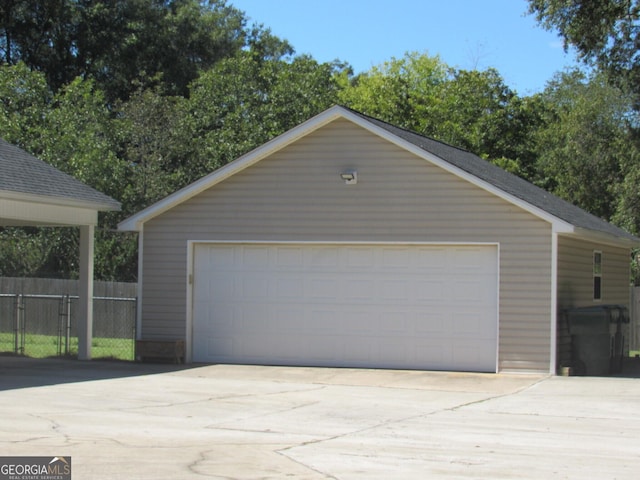 detached garage featuring fence