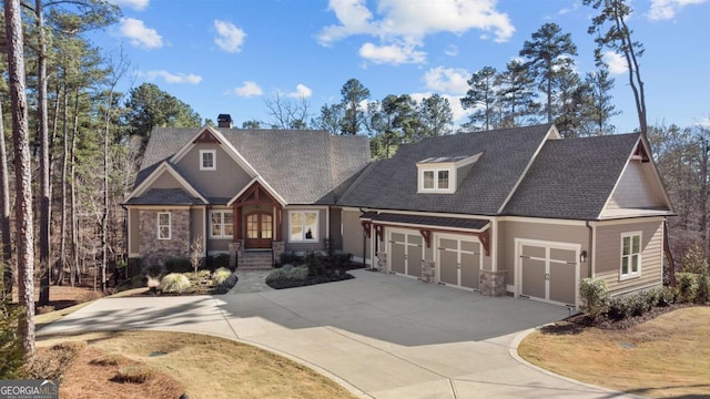 craftsman-style home featuring a garage and concrete driveway