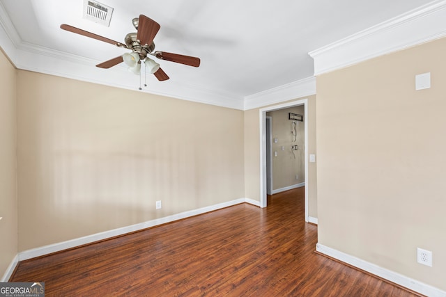 spare room featuring baseboards, visible vents, ceiling fan, ornamental molding, and wood finished floors