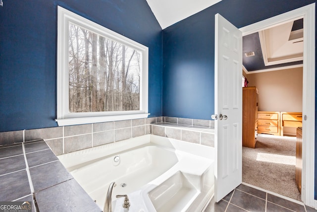 full bath with a tub with jets and tile patterned floors