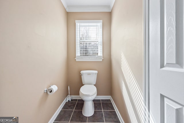 bathroom with ornamental molding, tile patterned flooring, baseboards, and toilet