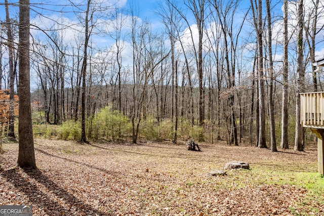 view of yard with a view of trees