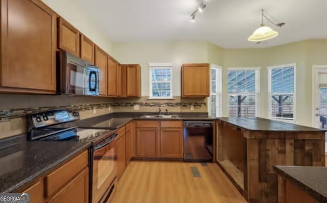 kitchen with dark countertops, electric range, a sink, black microwave, and dishwasher