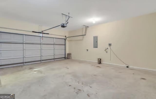 garage with a garage door opener and electric panel